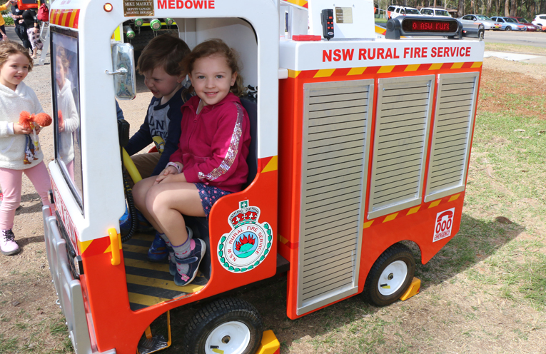 Archie and Ellie Green trying out ‘Mike’ the fire truck, made by Fire brigade volunteer Bill Taylor.