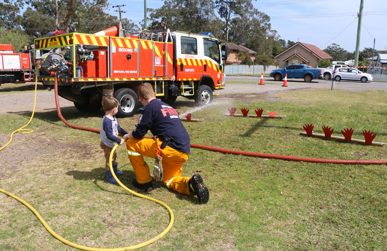 Children were taught how to hold the fire hose, and had fun knocking down the fire cutouts.