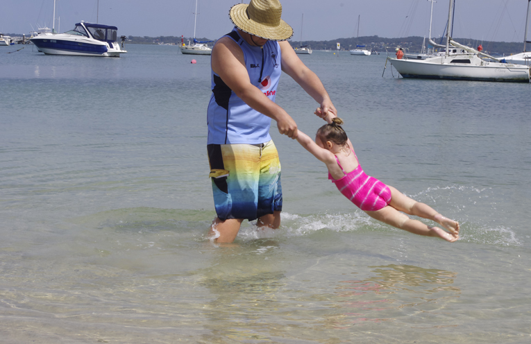 Indiana with her father Lucas Mccleer at the beach adjacent to Soldiers Point Marina. Photo by Marian Sampson