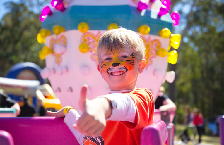 A little Tiger having fun on the teacup ride. Photo by Pete Neville
