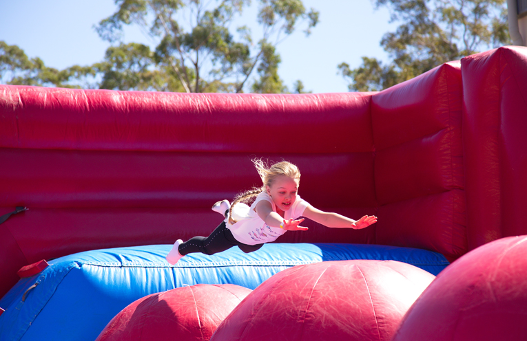 Scarlett Lewis on the bouncing pillow in the jumping castle. Photo by Pete Neville