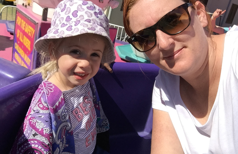 Cat Kelly and her three year old daughter having fun on the teacups.