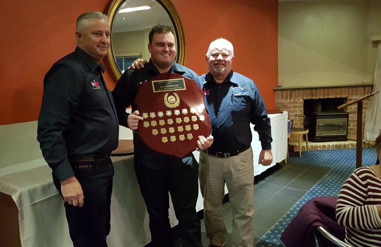 MOST IMPROVED: Coach Russell Gunn, Kayden John and President David Bright.