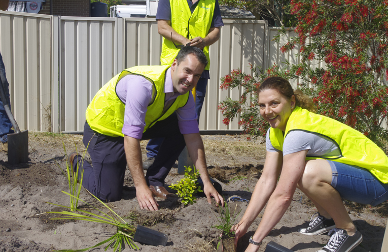 Mayor Ryan Palmer and Councillor Sarah Smith assisting with the planting at the newly installed garden at Anna Bay.