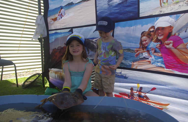 Charlotte and Haydon Drake with a Banjo Shark at the touch pool at Gone Fishing Nelson Bay. Photo by Marian Sampson