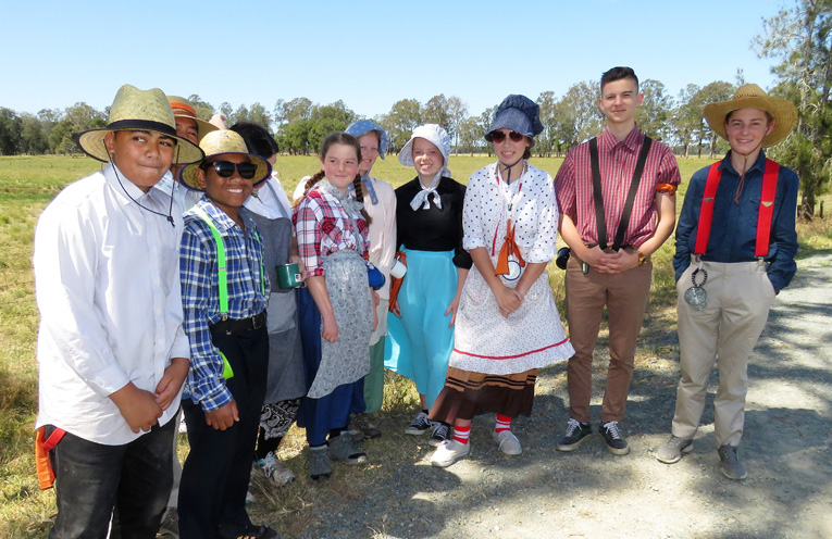 Teens dressed in pioneer clothing for the Bulahdelah trek. 