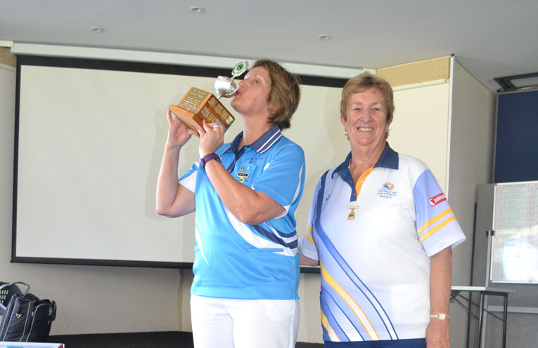 President of Karuah Women's Bowling Club Kim Post, kissing the Trophy with Robyn Webster, President of Tea Gardens Women's Bowling Club.