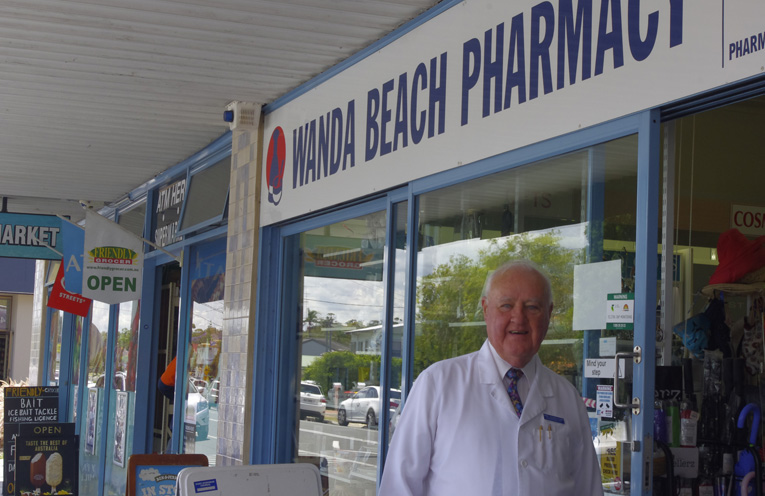Kerry Schiemer outside Wanda Beach Pharmacy where he still give good advice. Photo by Marian Sampson.