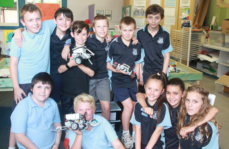 Students pictured with EV3 Lego Robotics. These computers have a larger 'brain' than the computers inside the Apollo Spacecraft which took man to the Moon.