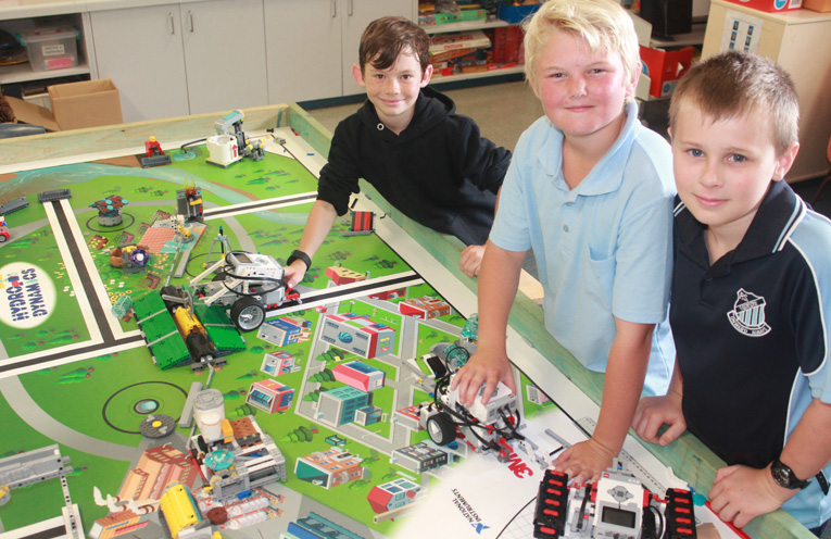 Caleb Whitter, Jackson Cheetham and Oska Greentree with some of the robotics equipment.