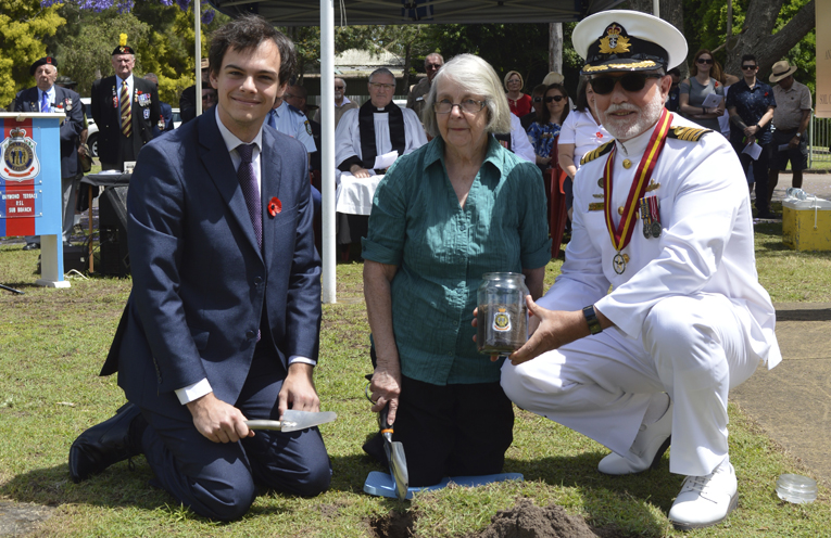Councillor Giacomo Arnott and Captain Victor Jones, RANR, President of the Raymond Terrace RSL Sub-branch assist the relative of Private Charles Wattus from World War I, collect soil for the Centenary project.