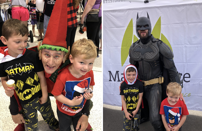 Eamon and Owen Brown meet a crazy elf. (left) Brothers Eamon and Owen meet Batman after he delivers Santa to the festival. (right)