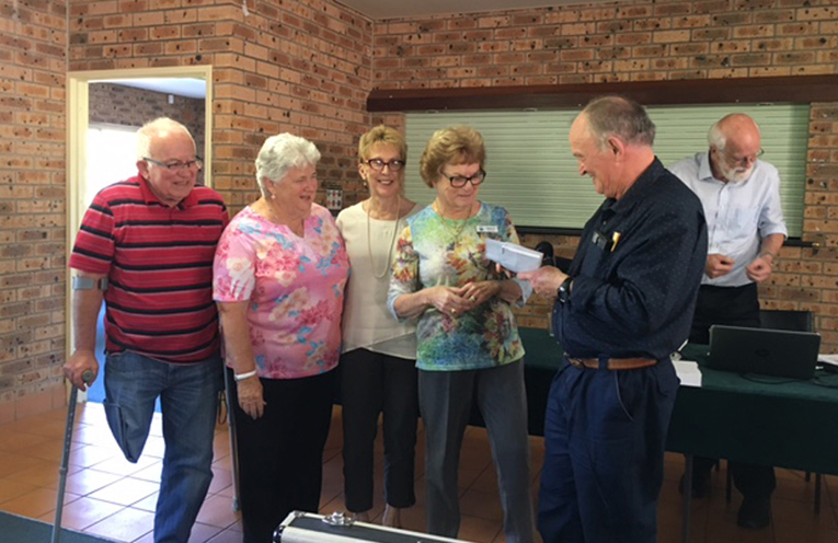 The winning Tomaree Bridge Club Team (Sunday Teams Event) Jim Thatcher, Evon Williams, Margaret Sylow and Carolyn Seymour with Tomaree Bridge Club president Kevin Farrell is presenting their prize.