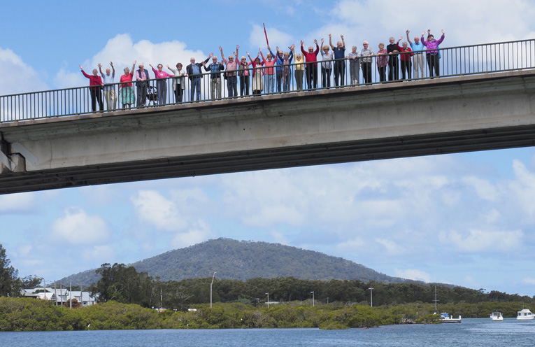 Some of the choir gathered on the Singing Bridge. Photo By Andrew Sillar