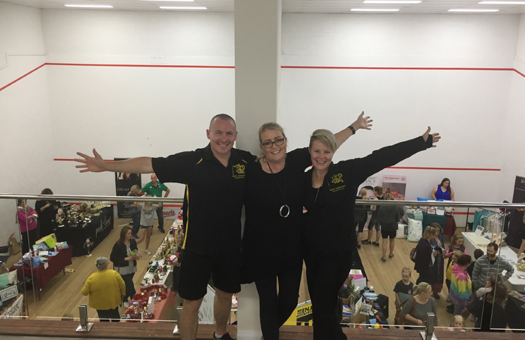 Tony Gillespie, Ali Binskin and Kelly O’Brien on the viewing deck above just some of the stalls within the squash courts.