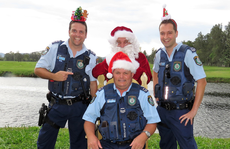 Merry Christmas: Sn Constables Ash Ray, Trevor McLeod and Dave Feeney enjoy a visit from Santa. 