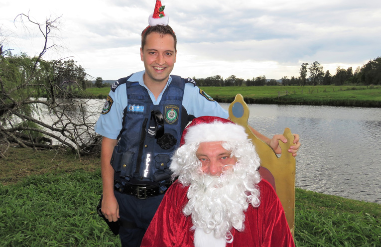 Sn Constable Dave Feeney enjoys a visit from Santa. 