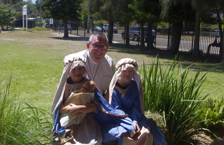 Father Brian Mascord Bishop Elect, with Mary (Piper Doro) and Joseph (Ashton Kime). Photo by Marian Sampson.
