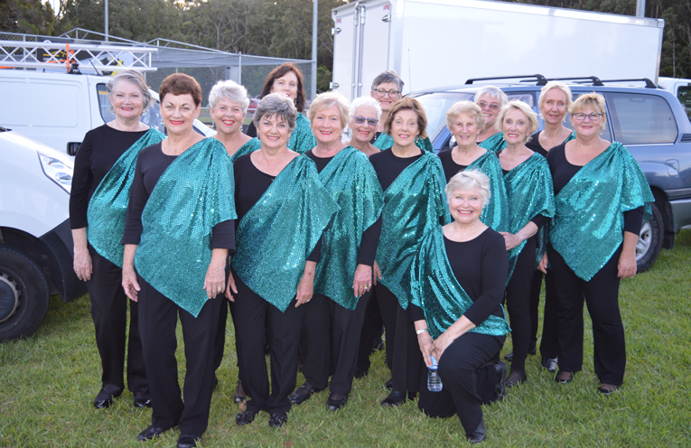 Women Of Note Choir with Music Director, Sandy O’Neill in the front.