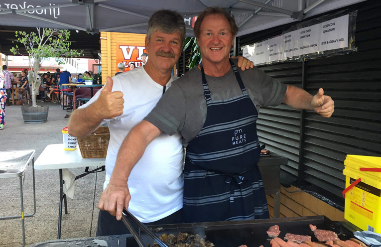 Barbecue kings Glenn Campbell and Ian Marshall cooking up a feast for the crowd.