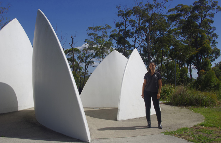 Port Stephens Council’s Maddie Rosenthal at the Vantage Estate Sculpture “Sails” by Hunter Sculptor Braddon Snape. Photo by Marian Sampson.