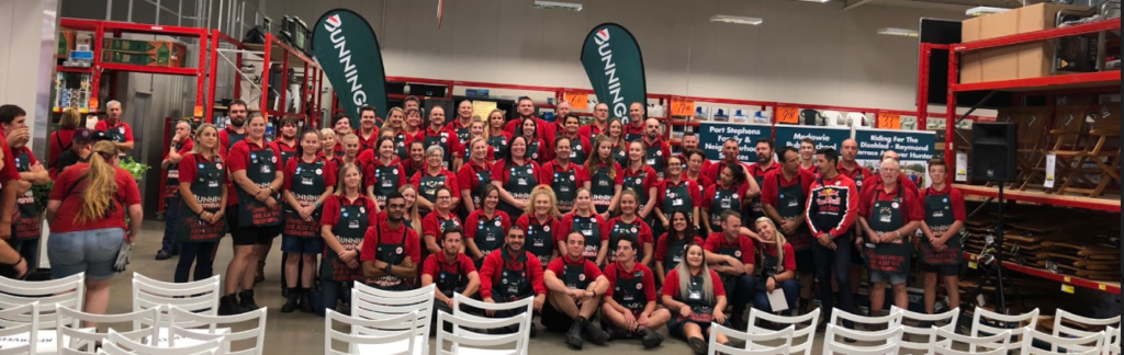  A sea of red and green - staff pose for a photo to mark the official opening of the Heatherbrae store.