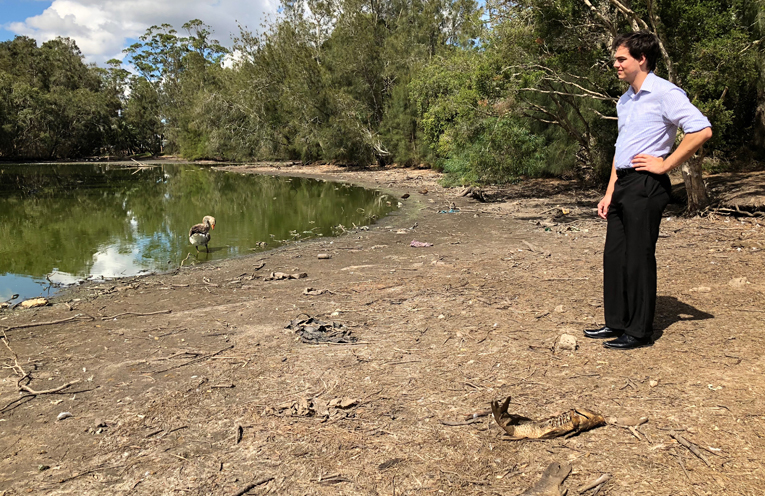 Councillor Arnott surveys the duck pond, surrounded by carp fish bodies.
