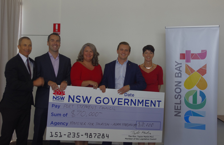 Port Stephens Council General Manager Wayne Wallis, with Mayor Ryan Palmer, Member for Paterson Meryl Swanson, The Honourable Taylor Martin MLC, and Member for Port Stephens and Kate Washington with the $70,000 State Government contribution to Nelson Bay CBD’s amenity. Photo by Marian Sampson.
