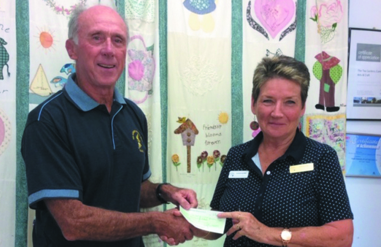MYALL COAST ART AND CRAFT CLUB DONATION: Surf Club President Tony Logue and MCACC President Sue Burns.