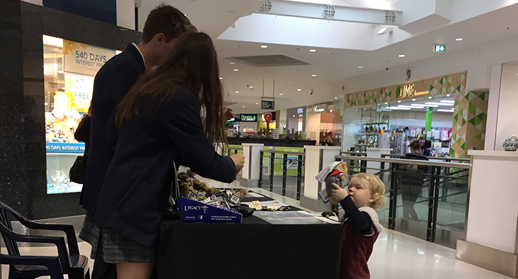 A young supporter purchasing a Legacy Nurse Bear.