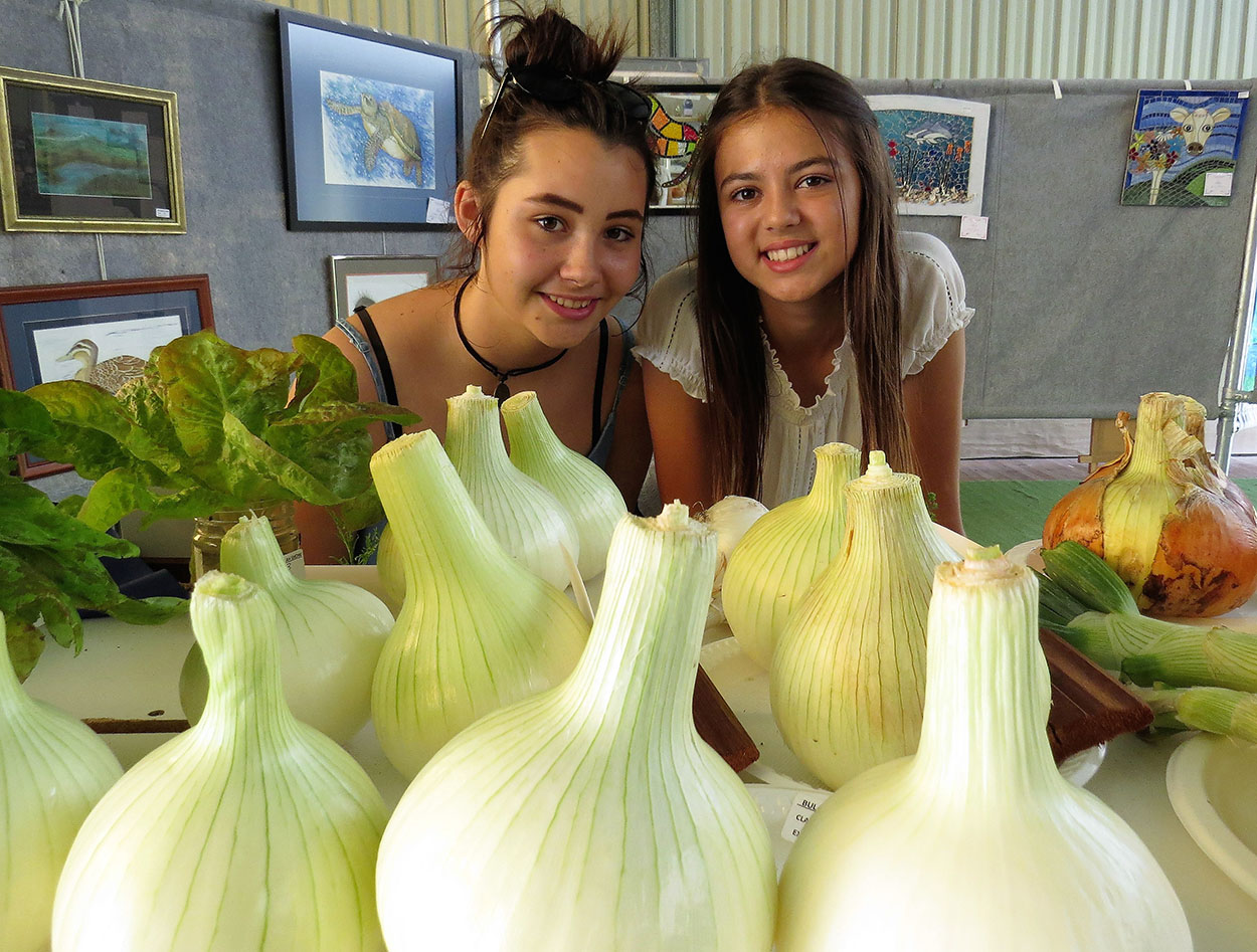 PRODUCE: Whitney Soars and Jaylee Tassell examine the largest onions on show