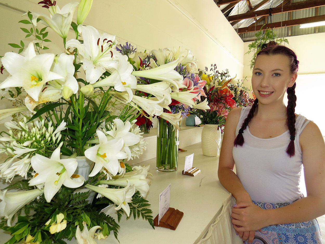 FLOWERS: Madison Shannon admires the colourful floral display