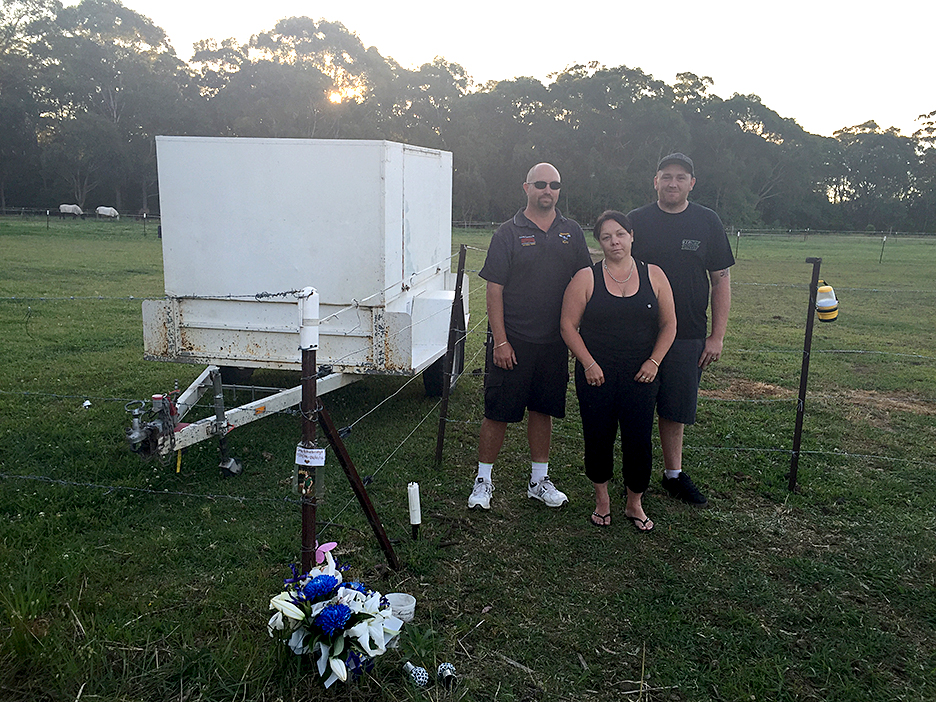 Corey’s step-father Alby, mother Michelle, and friend Chris at the site of the proposed permanent memorial.
