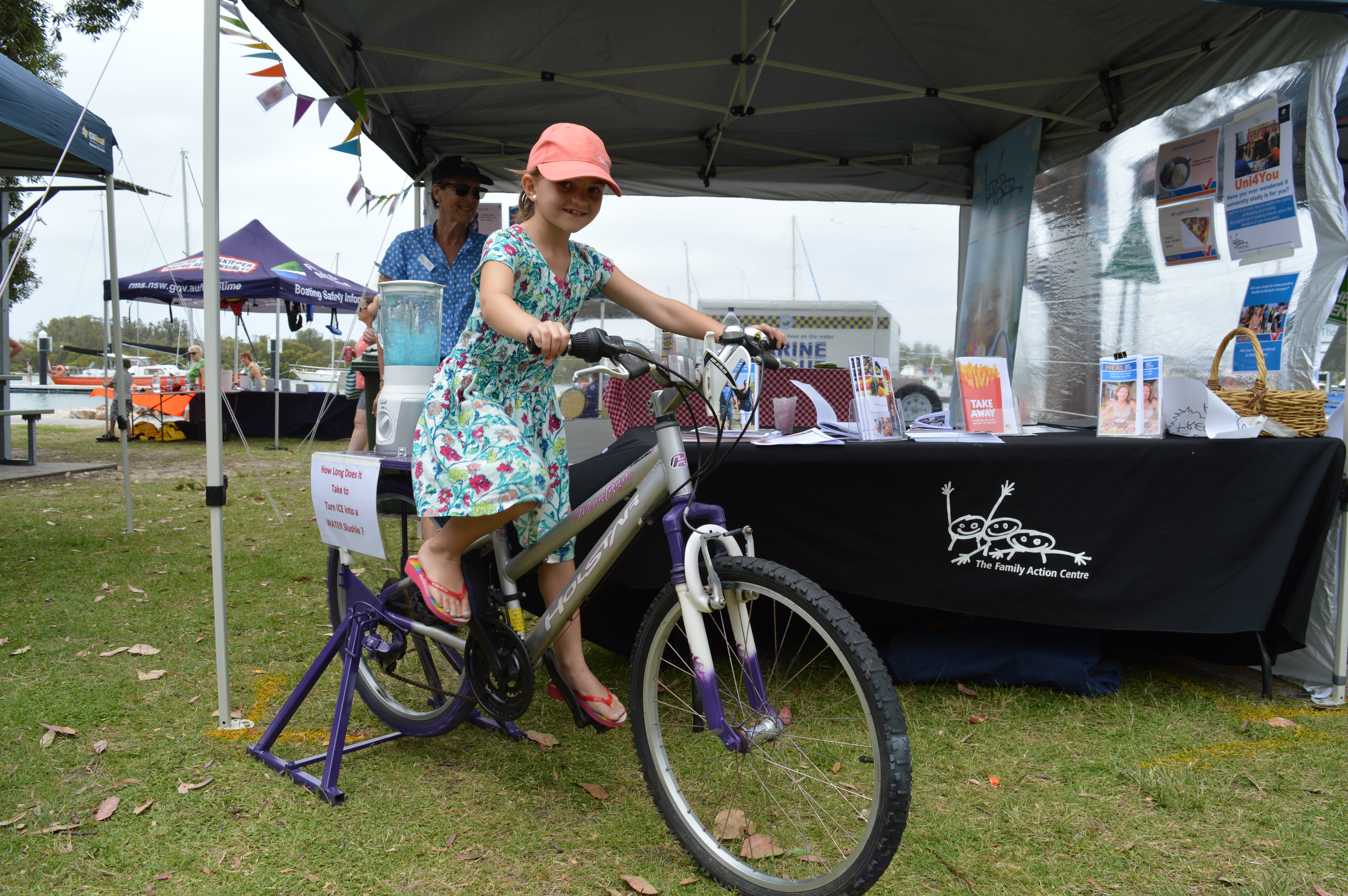 Olivia Hicks visiting from Merewether rides a bike to power a blender for the University of Newcastle’s Healthy Eating and Active Lifestyle (HEAL) program.