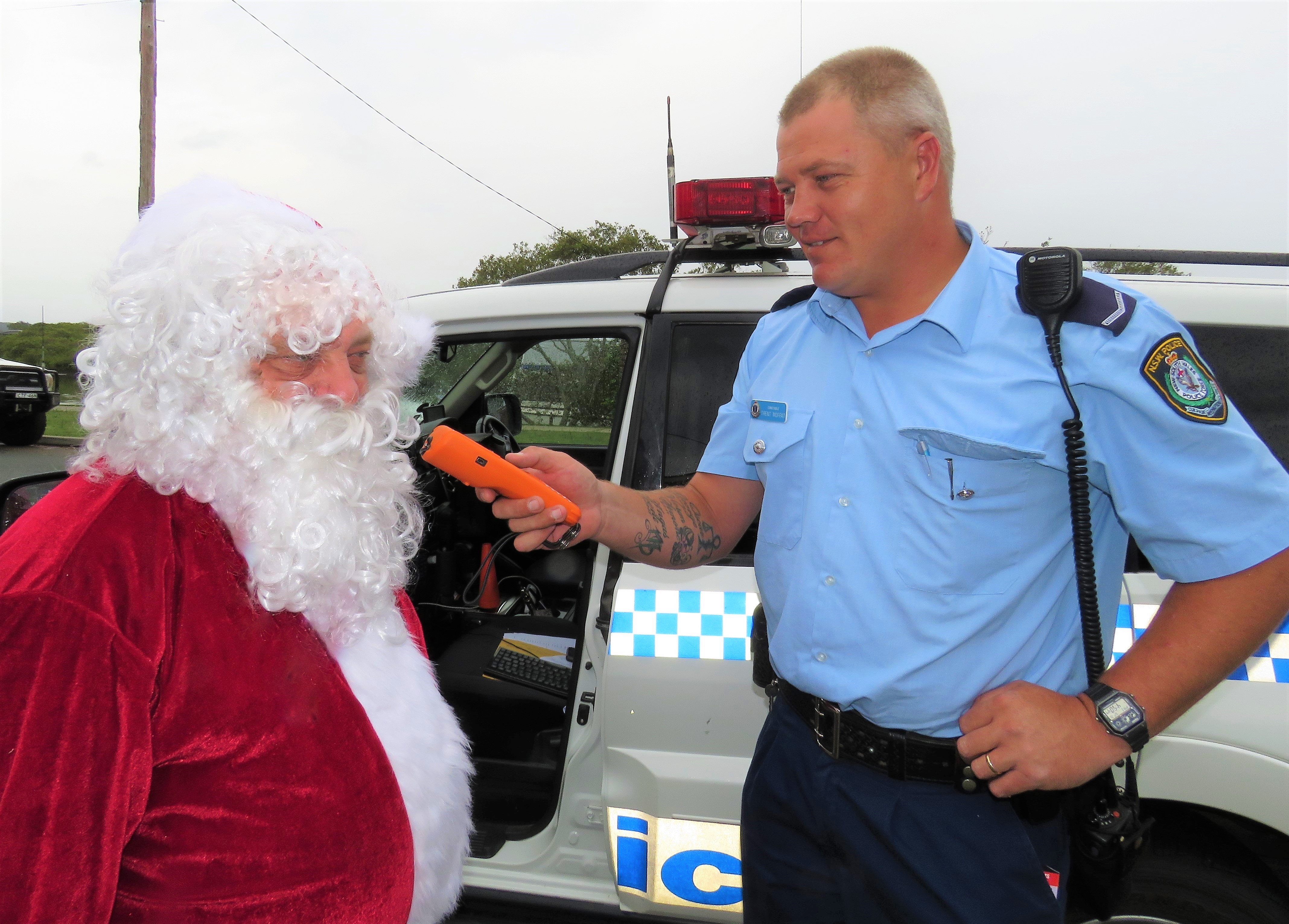 ANYWHERE, ANYTIME: Karuah Police Constable Trent Moffat gives Santa a roadside breath test