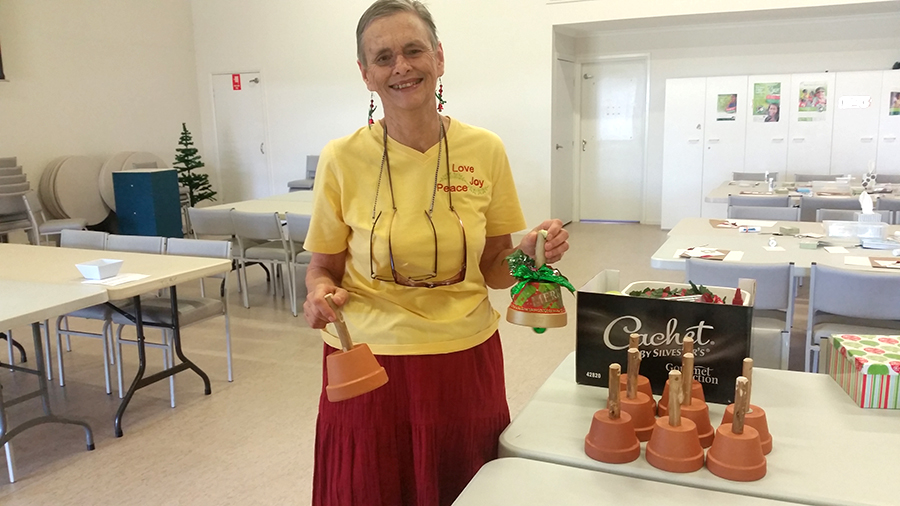 VOLUNTEER: Carolyn Bye with a Christmas bell creation.