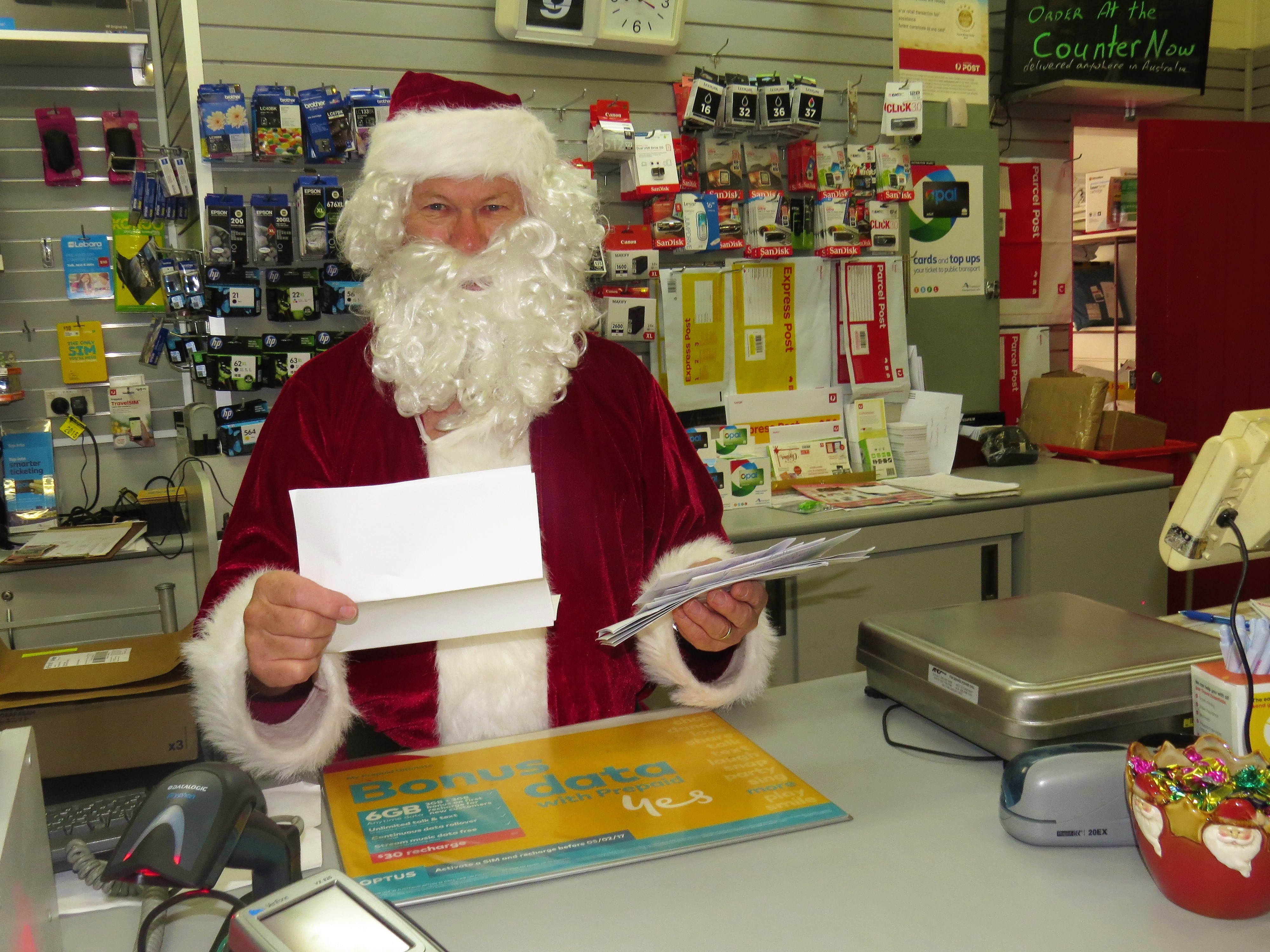 CHRISTMAS MAIL: Santa Claus reading the letters from children at Bulahdelah Post Office