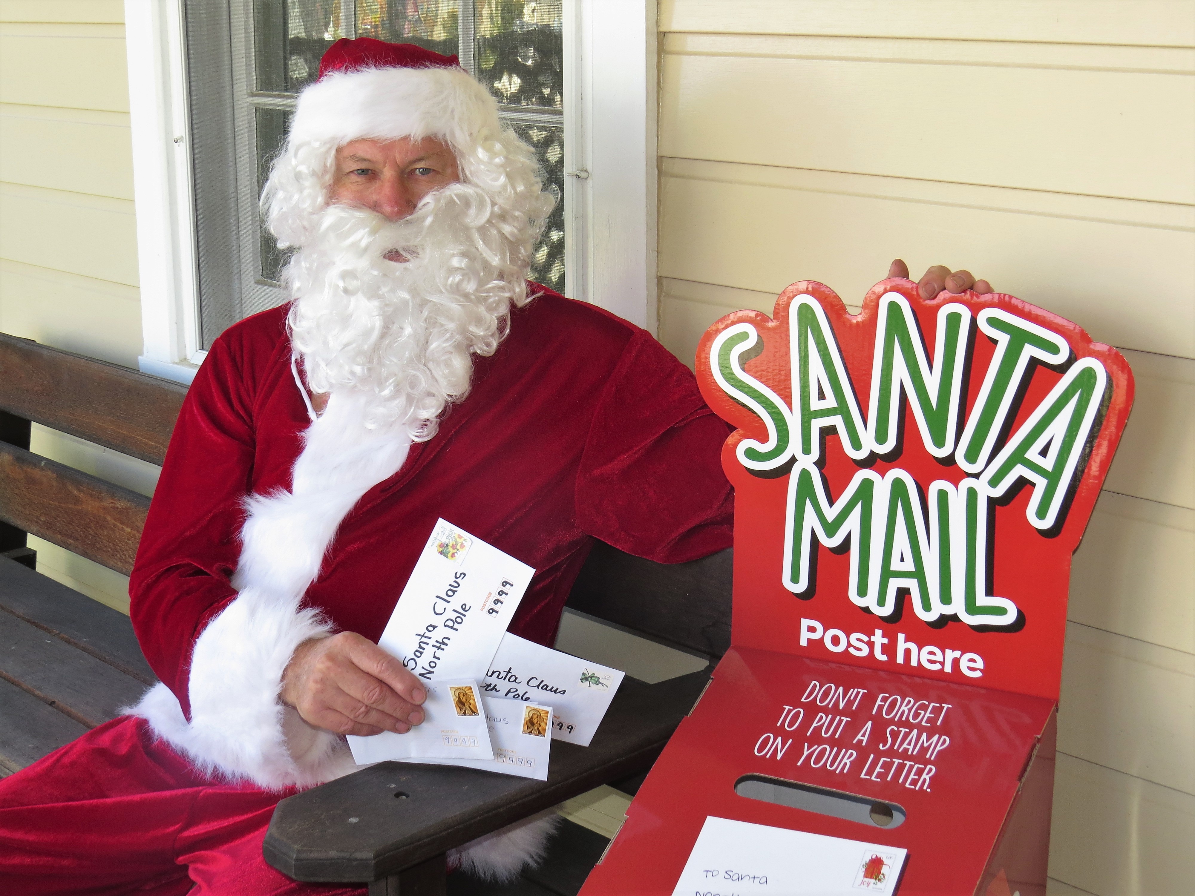 CHRISTMAS MAIL: Santa Claus collects letters from the special Santa Mailbox at Bulahdelah Post Office