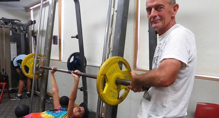 Weights: Year 8 student Dane Pope from Hawks Nest assisted by teacher Bob McCann.
