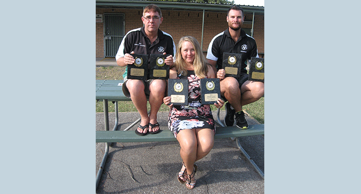 Canteen manager Lynn Sparks flanked by registrar John Eijkenboom and Club president Kris Sparks with trophies from 2016. 