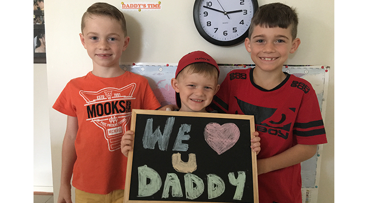Charlie, Jackson and William with a sign for their Dad.