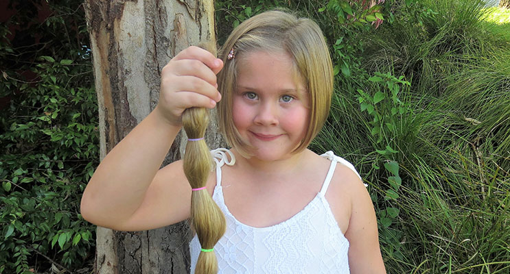 Locks Lopped: Kirra-Lea Rooney with her 45cm long ponytail which she donated to charity.  