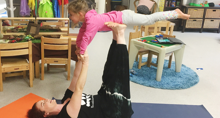 Ella completing an impressive superhero yoga move.
