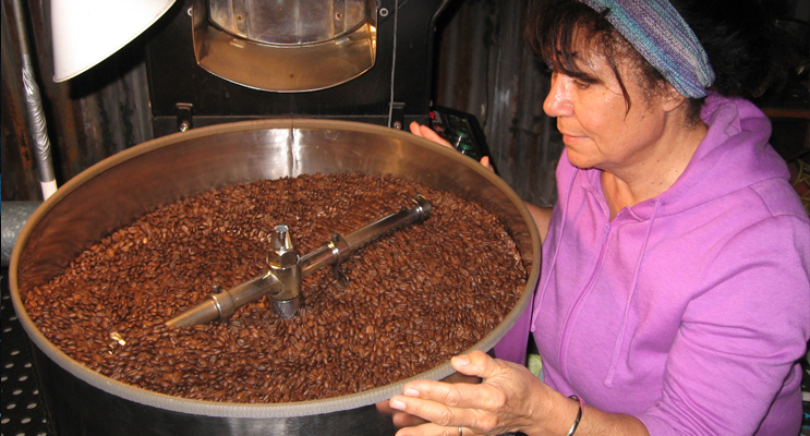   Jacqui with freshly roasted coffee beans at her Lemon Tree Passage headquarters.   