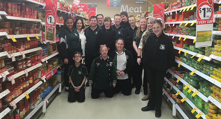 Students and staff from the Learning Support program with relieving Store Manager James Day.
