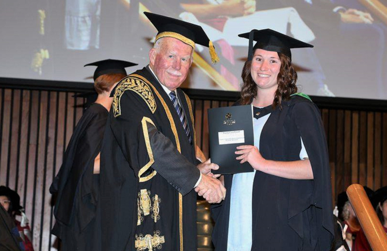 University Chancellor Paul Jeans presents Hayley Follett with her degree. Photo: Supplied 