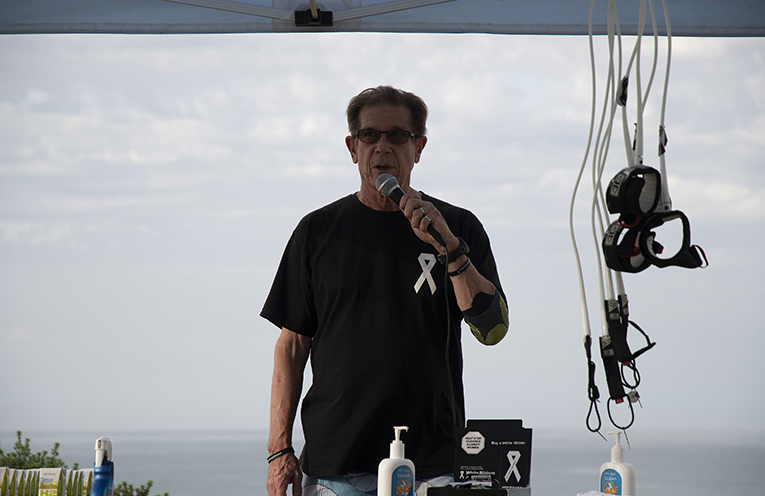 Local White Ribbon Ambassador Roger Yeo who lost his daughter to domestic violence  addressing the Walkers. Photo by Ethan Smith Surfing NSW.