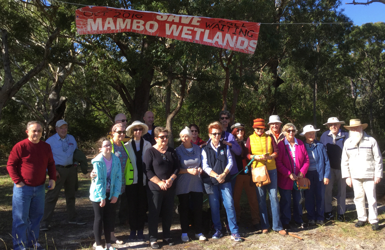 The community celebrating the removal of the Save Mambo Wanda Wetlands Banner.